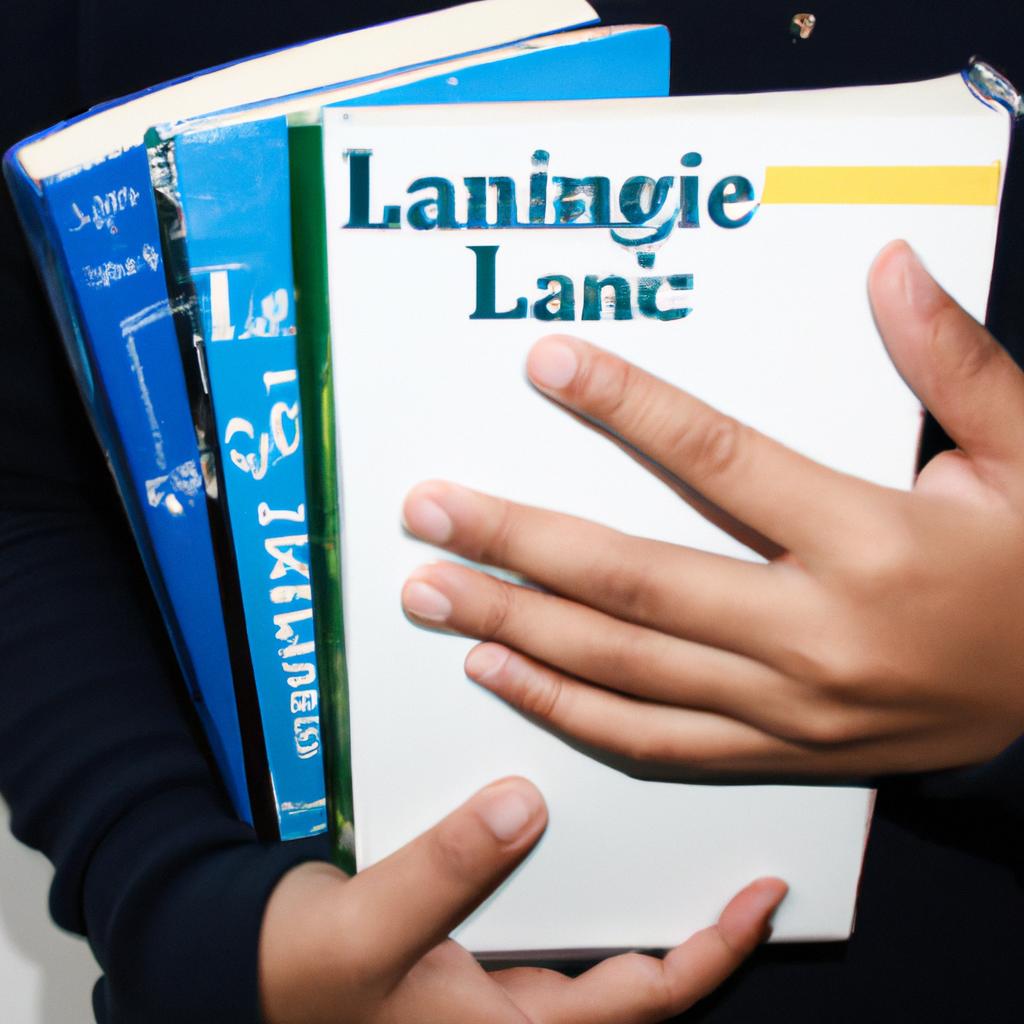 Person holding language textbooks